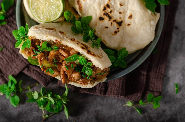 Delicious pita bread with meat, fresh herbs and caramelized onion