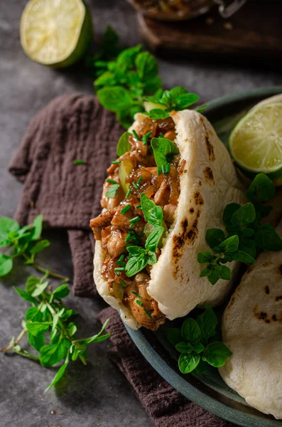 Delicious pita bread with meat, fresh herbs and caramelized onion