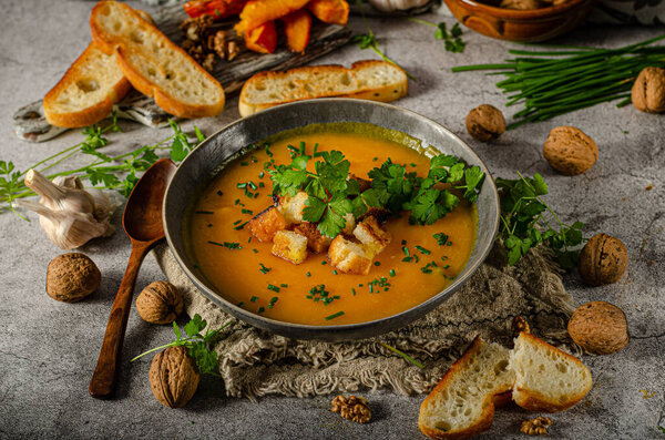 Creamy and delicious soup from roasted pumpkin, fresh herbs and crispy toast