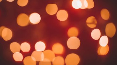 Odaklanamayan soyut Bokeh ışıkları arkaplanı. turuncu, kırmızı, siyah renkler. Noel ve yeni yıl konsepti