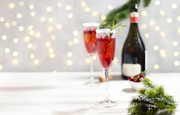 Mimosa festive drink for Christmas - champagne red cocktail Mimosa with cranberry for Christmas party, copy space