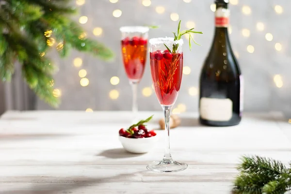 Mimosa festive drink for Christmas - champagne red cocktail Mimosa with cranberry for Christmas party, copy space