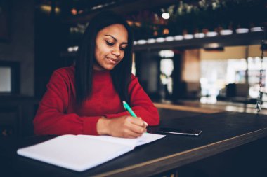 Çekici genç koyu tenli modeli not defterinde boş sayfaları kafe, kahvehane proje için bütçe planlama finansal notlar güzel afro Amerikan işkadını vakit ile yazma