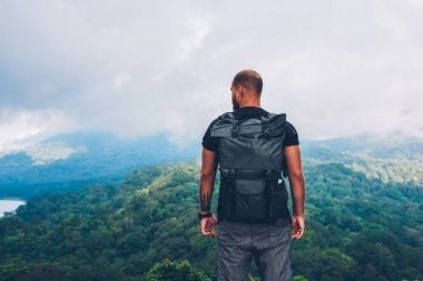 Arkadan görünüşü dağın tepesinde duran ve Treklerimiz macera yaşam tadını çıkarırken Asya ortamında yağmur ormanları ve yeşil manzara şaşırtıcı sahne hayran seyahat delikanlı sevgilisi