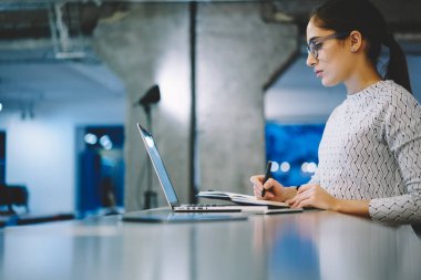 Profesyonel kadın araştırmacı modern teknolojileri kullanarak ve yapma bilgi çalışan laboratuvar analiz notları, içinde not etmek üstünde laptop tarama bilimsel test sonuç yazma Eyewear kadın