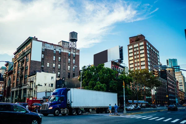 Publicity mock up area for advertising or commercial information Lightbox on exterior of modern buildings in urban setting, blank billboards on cargo van vehicle moving in city street,logistic company