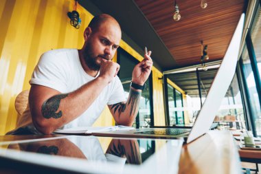 Konsantre erkek öğrenci el eğitim webinar online kurslar yoluyla bilgi almak izlerken kalem ile akıllı ciddi adam ağlardan bilgisi çözümlenirken hazırlamak yayın yapmak için 