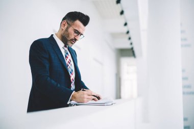 Dalgın olgun girişimci formal giyim ofis iç çalışma mali belgelerin incelenmesi giymiş. Bilgi okumada ve muhasebe raporları imzalama emin gurur CEO'su orta yaşları