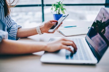 Kadın holding Smartphone ile dizüstü bilgisayar, netbook bluetoot yolu ile veri eşitleme için cep telefonu uygulaması kullanan kadın üzerinde işlem yapma onay mesajı alıyorum resim kırpılmış