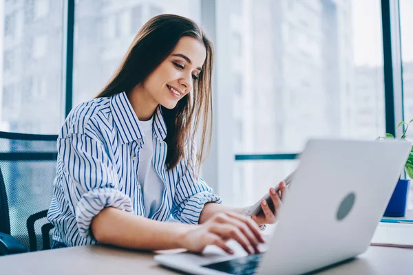 Smiling Young Female Freelancer Typing Laptop Computer While Reading Income — Stok Foto