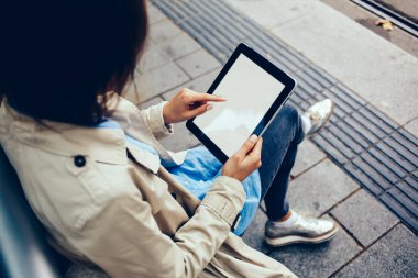 Modern tablet ile reklam Web siteniz için içerik boş ekran üzerinde metin yazarak parmak ile genç kadının üstten görünüm kırpılmış. Hippi kız App dijital dokunmatik yüzey ile kopyalama alanı alanı seçme