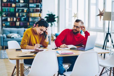 Ev iç togethe konsantre kadın kağıtları ve sonraki kocası oturan accountings yapmak faturaları kontrol ve dizüstü bilgisayar, Genç evlilik hesaplama, tartışırken aile bütçe planlama