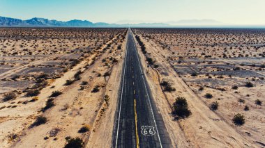 Aerial view of beautiful scenic landscape of desert environment and roadside, birds eye view of notable historic Route  with old pavement in America under dry climate sky clipart