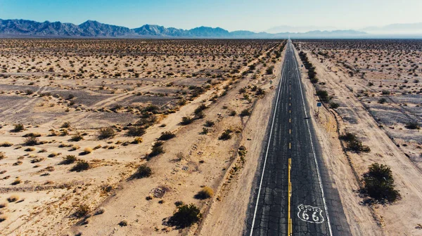 Reverse view of scenery landscape of Arizona National park and asphalt roadside, aerial view of scenic wild environment and historical landmark Route 66 in USA