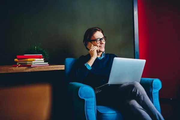 Cheerful Hipster Guy Talking Cellular While Sitting Comfortable Chair Laptop — Stock Photo, Image