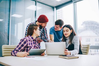 Dizüstü bilgisayar, eğitim webinar modern teknoloji kullanarak ve bilgi paylaşımı ders üzerinde işbirliği zeki pozitif meslektaşları arama başarılı kadın ve erkek öğrenci grubu