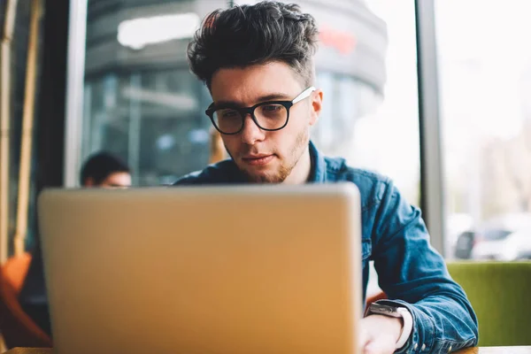 Pensive Male Student Eyewear Watching Learning Webinar Laptop Computer Studying — стоковое фото