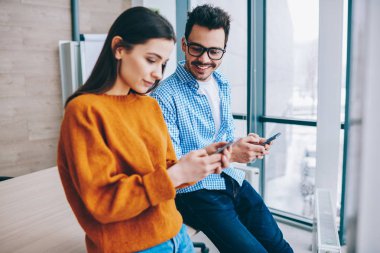 Modern akıllı telefonlar kullanarak Pozitif bin yıllık hipster çocuklar gerçek konuşma görmezden, genç erkek ve kadın çalışanlar teknolojileri ve internet ağ bağımlısı ve hücresel üzerinden sohbet