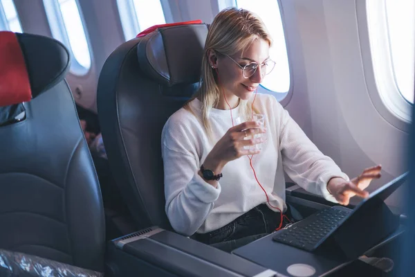 Smiling Attractive Female Passenger Watching Earphones Online Movie Touch Pad — Foto de Stock