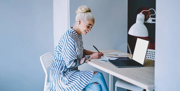 Cheerful Blonde Woman Student Doing Homework Indoors Sitting Desktop Using – stockfoto