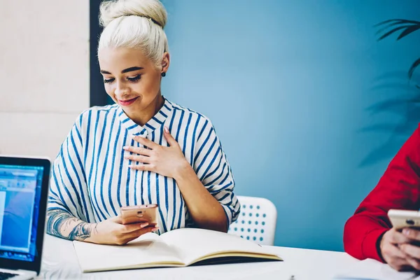 Positive Blonde Young Woman Pleased Getting Invitation Mobile Phone Sales – stockfoto