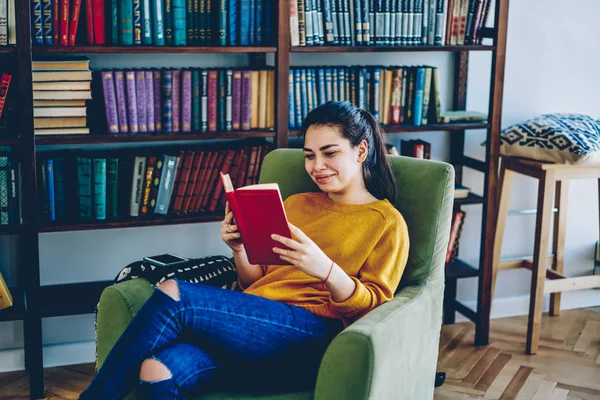 Positive Caucasian Woman Relaxing Armchair Interesting Novel Home Library Smiling — kuvapankkivalokuva