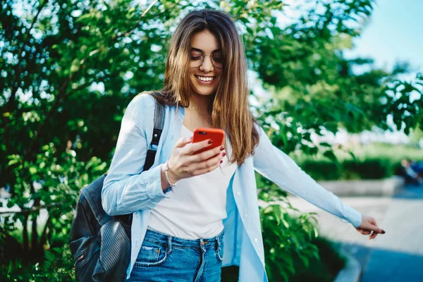 Cheerful Young Woman Reading Funny Notification Modern Smartphone Standing Backpack — Stock Photo, Image