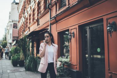 Moda kıyafetli çekici Gürcü kadın şehrin tarihi merkezinde cep telefonu konuşması yapıyor. Uluslararası turist internet üzerinden arama yapmak için gezici mobil bağlantı kullanıyor.