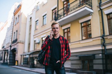 Sokakta telefonla konuşan kendine güvenen bir adam.