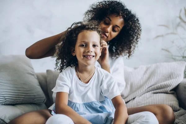 Büyüleyici küçük kızını ören kadın