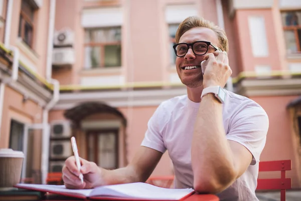 Cheerful Hipster Guy Phoning Colleague Discussing Details Organisation Plan Successful – stockfoto