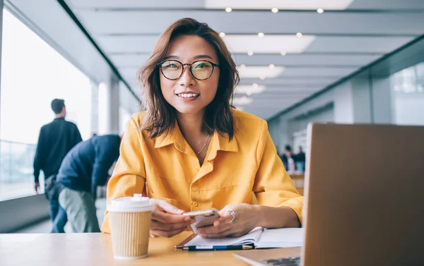 Portrait Chinese Positive Hipster Girl Trendy Spectacles Holding Cellphone Gadget — Stock Photo, Image