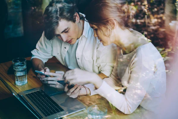 Millennial caucasian man and woman communicate with online customer service from provider company for consultancy about internet connection on cellular phones, concept of technology and generation