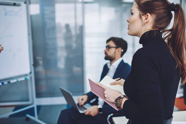 Crew of young professional people spending time for consultancy about information for business startup project, male and female coworkers communicate together in conference room during working process