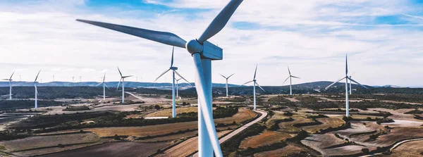Birds eye view of turbines propellers rotating from wind power producing clean eco energy and saving natural resources from climate change. Alternative electricity generation with friendly technology