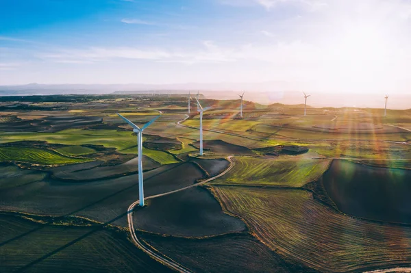 Aerial view of turbines propellers rotating from wind power producing clean eco energy and saving natural resources from climate change. Alternative electricity generation with friendly technology