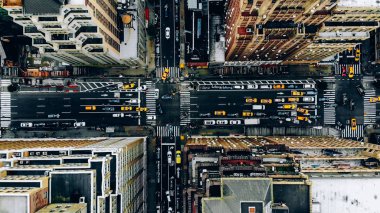 New York şehir merkezindeki bina çatılarının havadan görünümü. Cityscape Metropolis altyapı, trafik arabaları, sarı taksiler şehir sokaklarında hareket ve bölge caddeleri geçiş helikopter kuş bakışı görünümü
