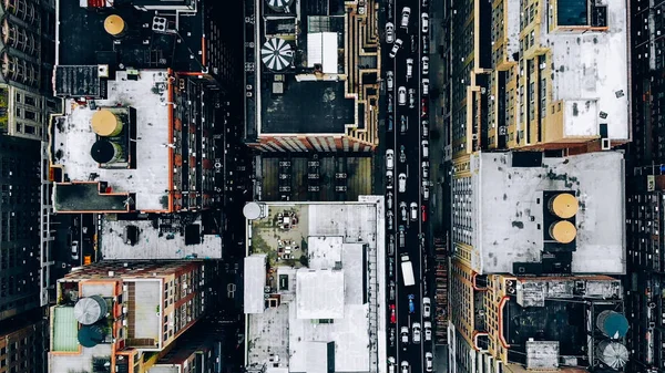 Aerial view of New York downtown building roofs with water towers. Bird\'s eye view from helicopter of cityscape metropolis infrastructure, traffic cars moving on city streets and district avenues