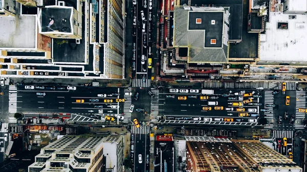 Aerial view of New York downtown building roofs. Bird\'s eye view from helicopter of cityscape metropolis infrastructure, traffic cars, yellow cabs moving on city streets and crossing district avenues