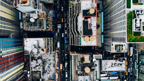 Aerial view of New York downtown building roofs with water towers. Bird\'s eye view from helicopter of cityscape metropolis infrastructure, traffic cars moving on city streets and district avenues