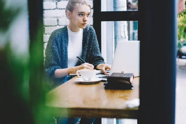 Пенсионерка учится с ноутбуком в кафе — стоковое фото