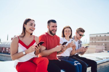 Sınırda akıllı telefon kullanan neşeli arkadaşlar