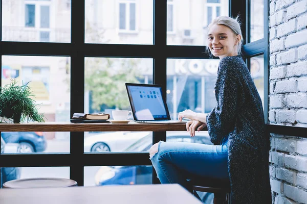 Charmant gelukkig meisje zitten met laptop in café — Stockfoto