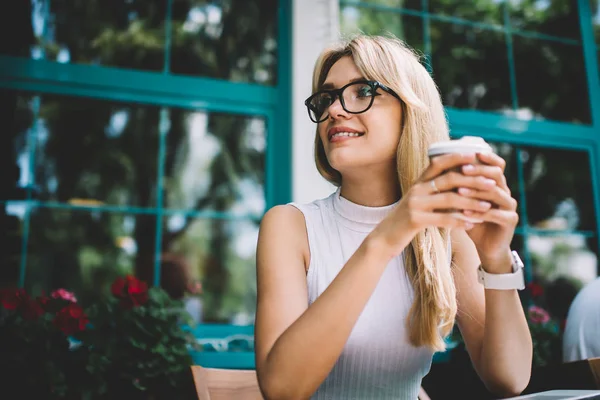 Mujer de moda con bebida caliente mirando hacia otro lado — Foto de Stock