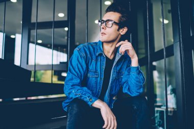 Kentsel ortamda serbest zaman boyunca düşünceli yeni optik gözlük hipster adam Pondering, tanıtım alanında moda giyim düşünme giymiş düşünceli erkek genç