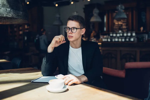 Pensive Male Restaurant Administrator Black Jacket Eyewear Sitting Cellphone Pen — Stock Photo, Image