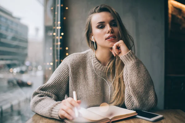 Thoughtful Young Lady Casual Wear Earphones Creating Plan Opened Book — Stock Photo, Image