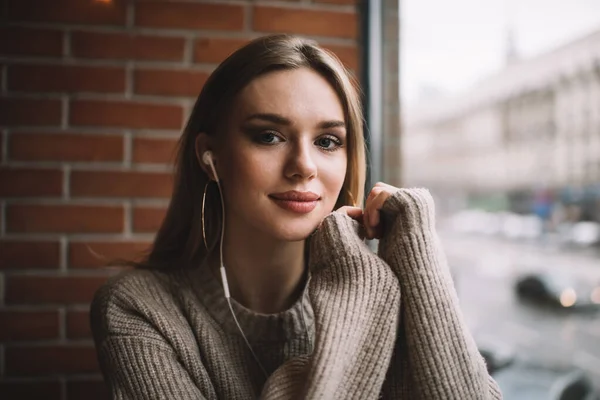 Young Female Long Blond Hair Sweater Earbuds Light Smile Looking — Stock Photo, Image