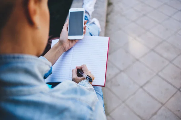 Från Ovan Beskära Anonyma Kvinnliga Anteckningar Copybook Och Surfa Mobiltelefon — Stockfoto