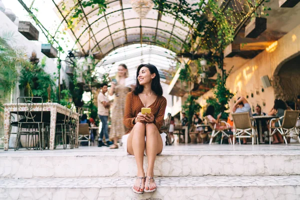 Full Body Cheerful Female Black Hair Sitting Cafe Browsing Smartphone — Stock Photo, Image